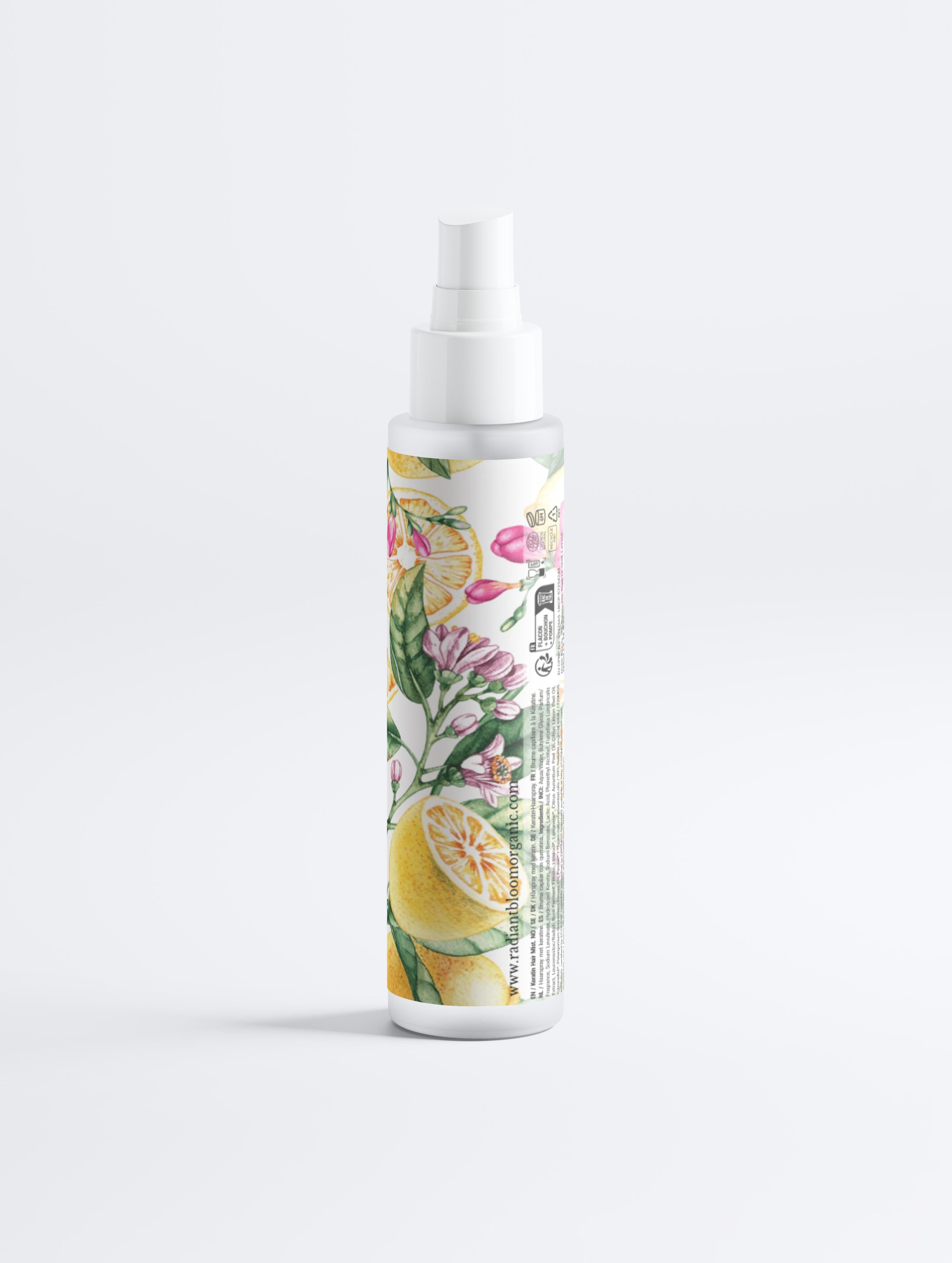 Spray bottle with floral and lemon design on a white background