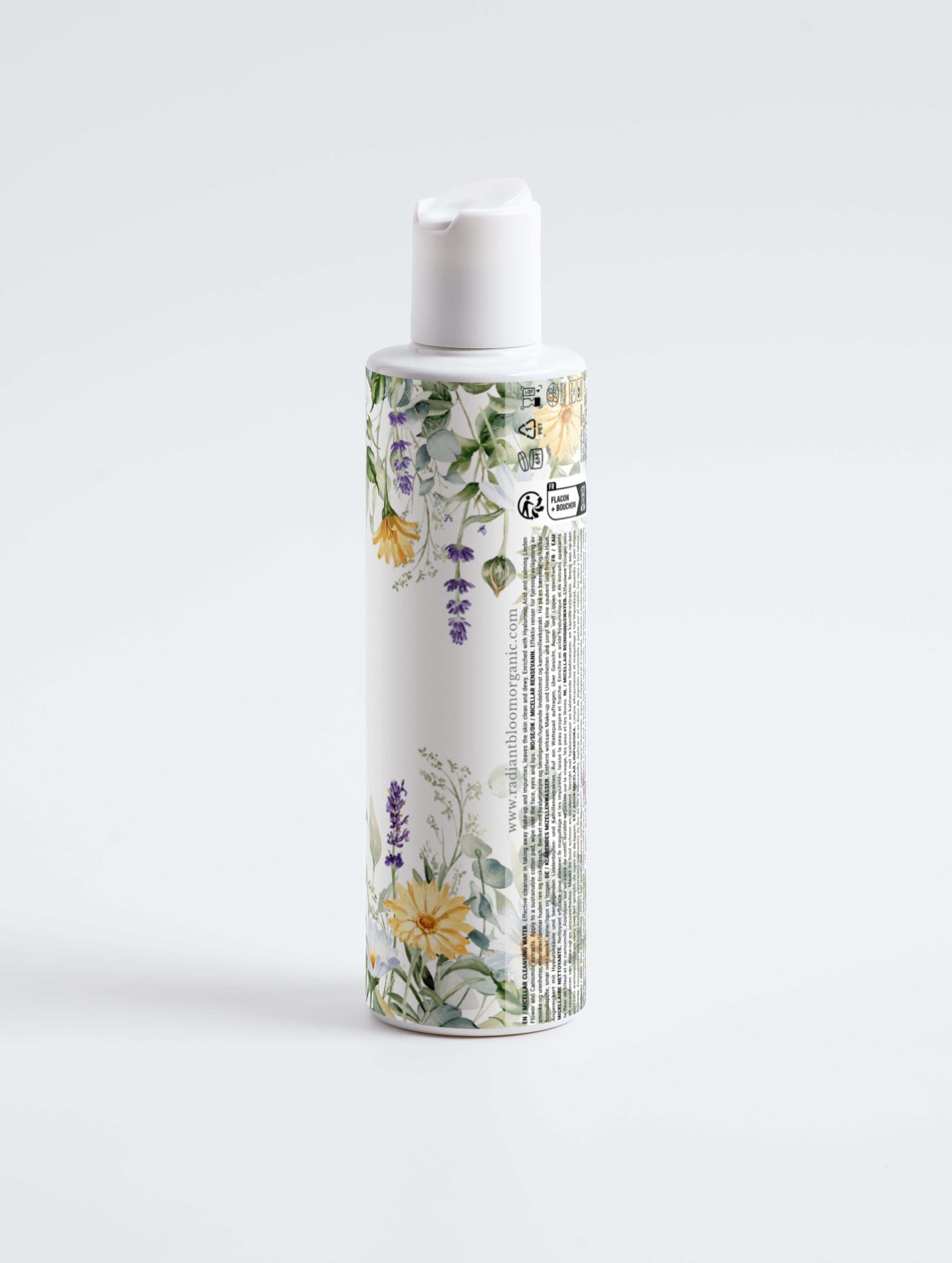 Micellar cleansing water bottle, back view with floral label and white pump cap
