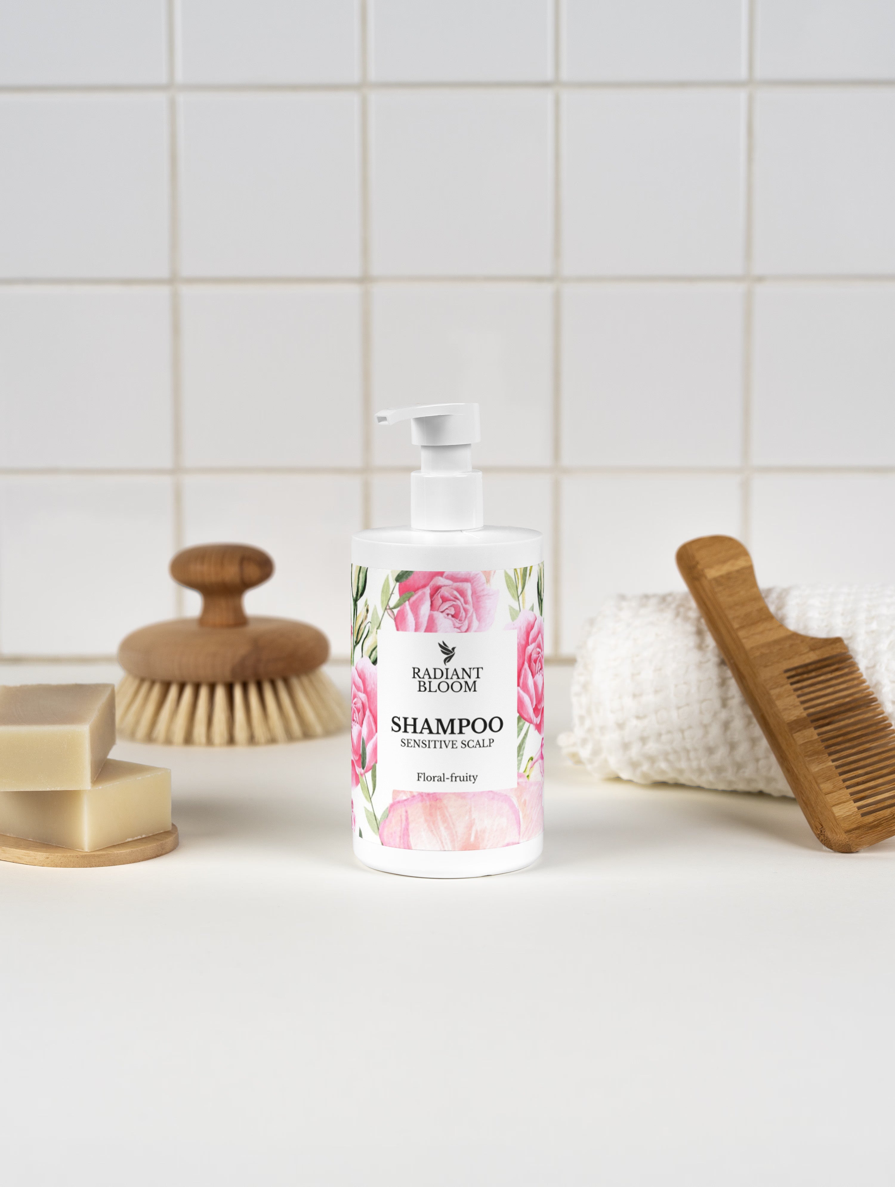 Shampoo bottle with floral design on a bathroom counter with a brush and soap dish.